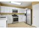 Bright kitchen with stainless steel appliances, white cabinets, and sleek countertops at 2032 Kingswinford Dr, North Las Vegas, NV 89032