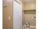 Functional laundry room featuring a door, shelf, and connections for a washer and dryer at 2032 Kingswinford Dr, North Las Vegas, NV 89032