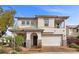 Charming two-story home featuring a desert landscape, stone accents, and an attached two-car garage at 2098 Valley Sand St, Las Vegas, NV 89135