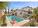 Relaxing backyard pool area includes a pool with a flamingo float and lush landscaping at 2098 Valley Sand St, Las Vegas, NV 89135