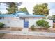 Charming single-story home featuring a blue-tiled roof, private courtyard, and mature trees at 2121 Twickenham Pl # D, Las Vegas, NV 89108