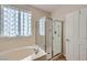 Bright bathroom with tub and separate glass enclosed shower at 2148 Shadow Canyon Dr, Henderson, NV 89044