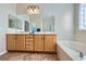 Bathroom vanity with double sinks, a large mirror and soaking tub at 2148 Shadow Canyon Dr, Henderson, NV 89044