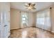 Neutral bedroom with two windows and decorative leaf fan at 2148 Shadow Canyon Dr, Henderson, NV 89044