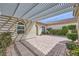 Charming courtyard features brick pavers, a pergola, and manicured landscaping, creating a private outdoor space at 2148 Shadow Canyon Dr, Henderson, NV 89044