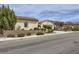 Inviting single-story residence showcasing desert landscaping, a tile roof, and a two-car garage at 2148 Shadow Canyon Dr, Henderson, NV 89044