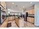 Spacious kitchen with granite counters, stainless steel appliances, and island, with adjacent living area at 2148 Shadow Canyon Dr, Henderson, NV 89044