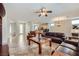 Spacious living room with tile floors, neutral walls, and an open layout to the kitchen at 2148 Shadow Canyon Dr, Henderson, NV 89044