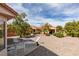 Spacious backyard features desert landscaping, a covered patio and seating area at 2194 King Mesa Dr, Henderson, NV 89012