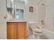 Bright bathroom features an oak vanity, combined tub and shower, and modern fixtures at 2194 King Mesa Dr, Henderson, NV 89012