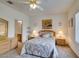 Bedroom with neutral carpet features a ceiling fan and access to the bathroom at 2194 King Mesa Dr, Henderson, NV 89012