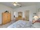 Bedroom includes a ceiling fan, wood dresser, and access to the bathroom at 2194 King Mesa Dr, Henderson, NV 89012
