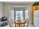 Bright breakfast nook features a wood table, chairs, and sliding door to the backyard at 2194 King Mesa Dr, Henderson, NV 89012
