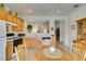 Well-lit kitchen features tile floors, oak cabinets, and a full-sized refrigerator at 2194 King Mesa Dr, Henderson, NV 89012