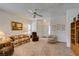 Comfortable living room with a ceiling fan, neutral carpet, and lots of natural light at 2194 King Mesa Dr, Henderson, NV 89012