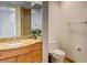 Bathroom featuring granite countertops, wood cabinets, and a toilet at 2240 Village Walk Dr # 2207, Henderson, NV 89052