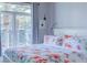 Inviting bedroom with floral bedding and a large window showcasing palm tree views at 2240 Village Walk Dr # 2207, Henderson, NV 89052