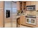 Bright kitchen featuring stainless steel appliances, granite countertops, and wooden cabinetry at 2240 Village Walk Dr # 2207, Henderson, NV 89052