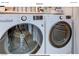 Convenient laundry room boasts modern washer and dryer set, plus shelving at 2240 Village Walk Dr # 2207, Henderson, NV 89052
