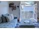 Cozy living room with blue sofa, ottoman, shelving and access to an outdoor balcony at 2240 Village Walk Dr # 2207, Henderson, NV 89052