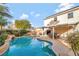 Relaxing pool area with lush landscaping and a covered patio for outdoor dining at 2293 Bull Lake Dr, Henderson, NV 89052