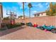 This backyard has a large brick patio, basketball hoop, and playset at 2410 Morocco Ave, North Las Vegas, NV 89031
