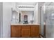 Bright bathroom with dual sinks, tile floors, and glass shower at 2410 Morocco Ave, North Las Vegas, NV 89031