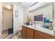 Standard bathroom with a single sink vanity, mirror, and toilet at 2410 Morocco Ave, North Las Vegas, NV 89031
