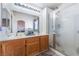 Bright bathroom with dual sinks, tile floors, and glass shower at 2410 Morocco Ave, North Las Vegas, NV 89031