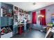 Playful bedroom with a desk, shelves, and red curtains at 2410 Morocco Ave, North Las Vegas, NV 89031