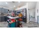 Well-lit kitchen featuring modern gray cabinets, stainless steel refrigerator, and an island with countertop seating at 2410 Morocco Ave, North Las Vegas, NV 89031