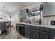 Well-appointed kitchen featuring gray cabinets, stainless steel dishwasher, and modern countertop with a dining area at 2410 Morocco Ave, North Las Vegas, NV 89031