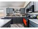 Contemporary kitchen with gray cabinets, stainless steel appliances, and a stylish countertop space for preparing meals at 2410 Morocco Ave, North Las Vegas, NV 89031