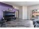 Cozy living room with sliding glass doors and modern finishes and grey wood floors at 2410 Morocco Ave, North Las Vegas, NV 89031