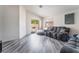 Comfortable living room with grey wood floors and sliding glass door leading to backyard at 2410 Morocco Ave, North Las Vegas, NV 89031