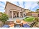 This backyard features artificial turf, a stone fire pit, and a covered patio at 260 Pioneers Peak, Henderson, NV 89002