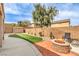 Backyard featuring artificial turf, a stone fire pit, and privacy walls at 260 Pioneers Peak, Henderson, NV 89002