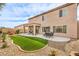 Backyard featuring artificial turf, gravel, and a covered patio at 260 Pioneers Peak, Henderson, NV 89002