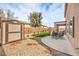 Backyard featuring artificial turf, gravel, and a covered patio at 260 Pioneers Peak, Henderson, NV 89002