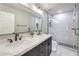 Modern bathroom featuring a glass-enclosed shower, double vanity, and sleek black fixtures at 260 Pioneers Peak, Henderson, NV 89002
