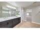 Bright bathroom featuring a double vanity with a quartz countertop and modern fixtures at 260 Pioneers Peak, Henderson, NV 89002