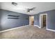 Bedroom with a ceiling fan, carpet, floating shelves, and ensuite bathroom access at 260 Pioneers Peak, Henderson, NV 89002
