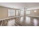 Large bedroom with hardwood floors, a ceiling fan, and plantation shutters at 260 Pioneers Peak, Henderson, NV 89002