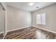 This bedroom has wood laminate floors, neutral walls, and a bright window with blinds at 260 Pioneers Peak, Henderson, NV 89002