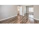 A well-lit bedroom with wood laminate floors, neutral walls, and mirrored closet doors at 260 Pioneers Peak, Henderson, NV 89002