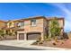 Attractive two-story home with a tile roof, desert landscaping, and an attached two-car garage at 260 Pioneers Peak, Henderson, NV 89002