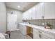 Bright laundry room with ample storage, modern appliances, and stylish tile backsplash at 260 Pioneers Peak, Henderson, NV 89002