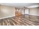 Open-concept living room featuring hardwood floors, a ceiling fan, and staircase at 260 Pioneers Peak, Henderson, NV 89002