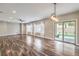 Open living space featuring hardwood floors, large windows, and sliding glass doors to the backyard at 260 Pioneers Peak, Henderson, NV 89002