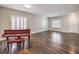 Spacious living room with hardwood floors, plantation shutters and a beautiful grand piano at 260 Pioneers Peak, Henderson, NV 89002